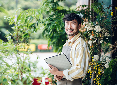 Portrait of confident young Asian male florist